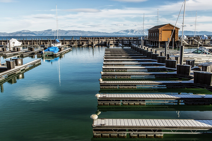 Boat dock in Lake Tahoe with mountains in the background